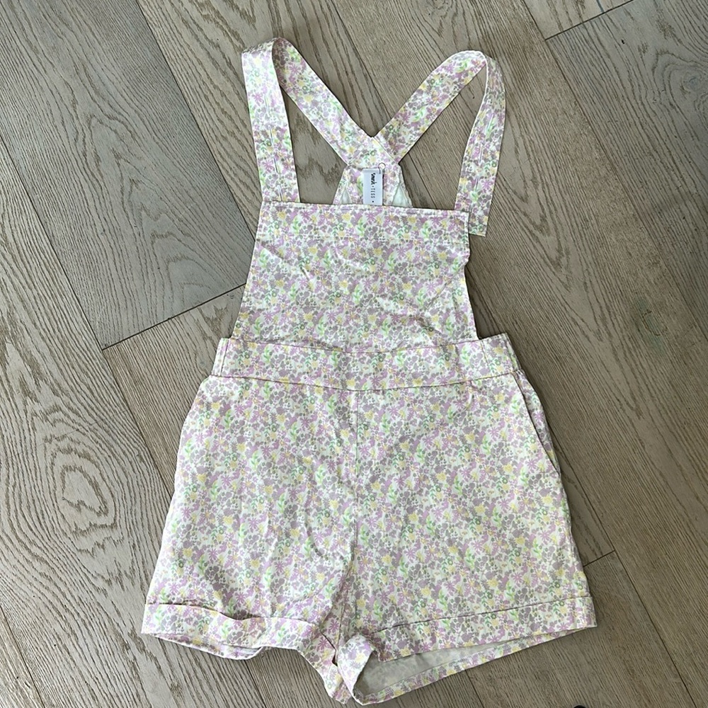 Medium smash and Tess floral overall shorts.